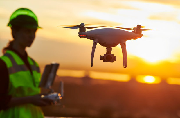 Worker operates drone for inspection